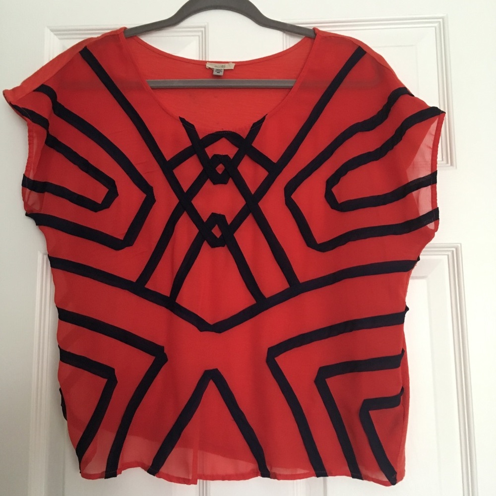 Red sheer blouse with navy geometric pattern